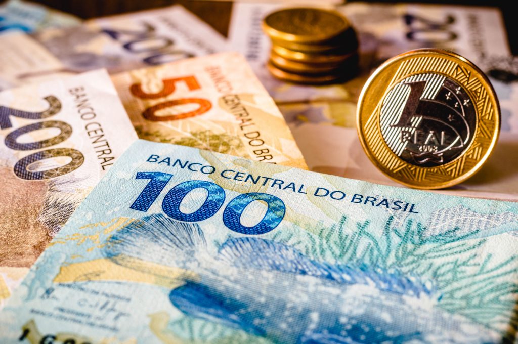 In this photo illustration being displayed fifty, one hundred and two hundred reais bills and a one reais coin highlighted. The Real is the current money in Brazil